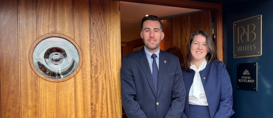 Morven and Anthony stand at the door to Fingal.