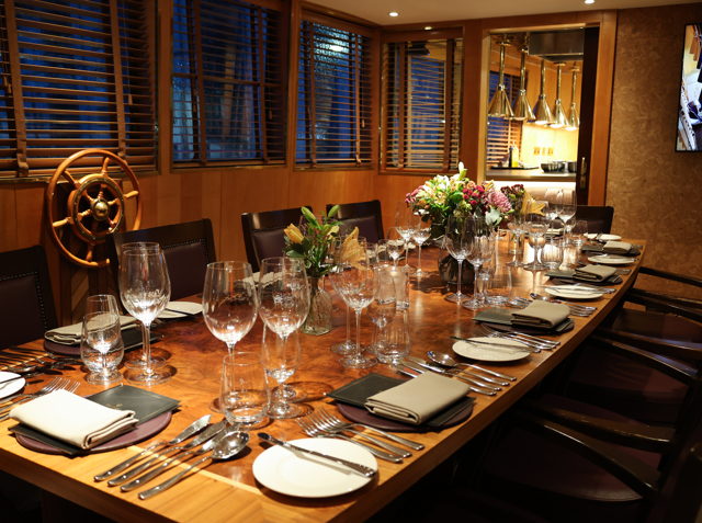 Fingal's Bridge containing a large, long dining table set for dinner. 
