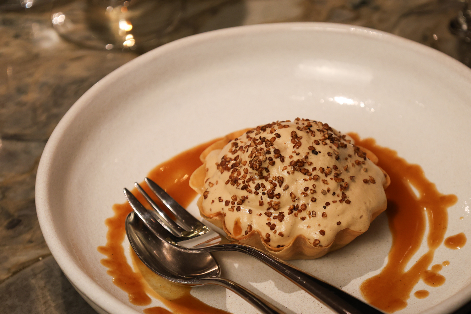 Dessert on a plate with syrup nicely poured around it. 