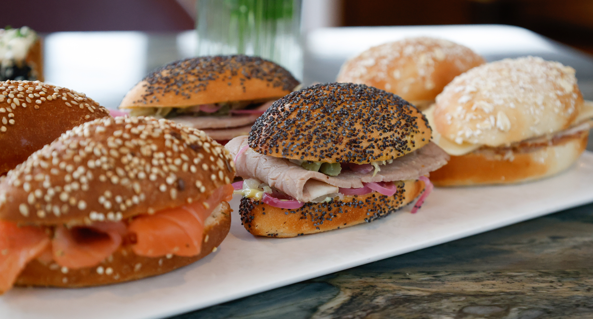 Smoked salmon, wasabi crème fraîche & dill navette and roast beef, gherkins & picked spring cabbage navette