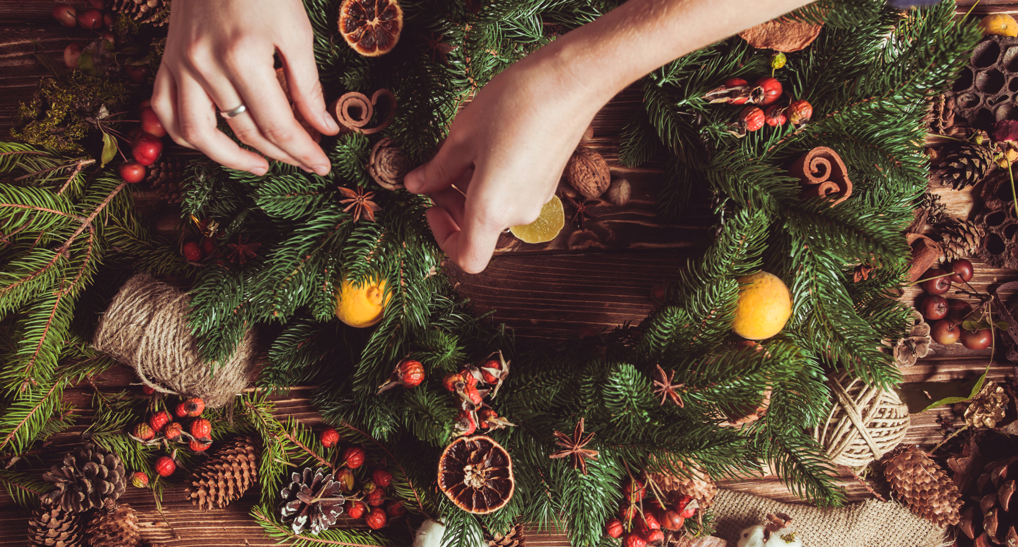 Hands craft a Christmas wreath during a festive wreath-making workshop event in an Edinburgh hotel 